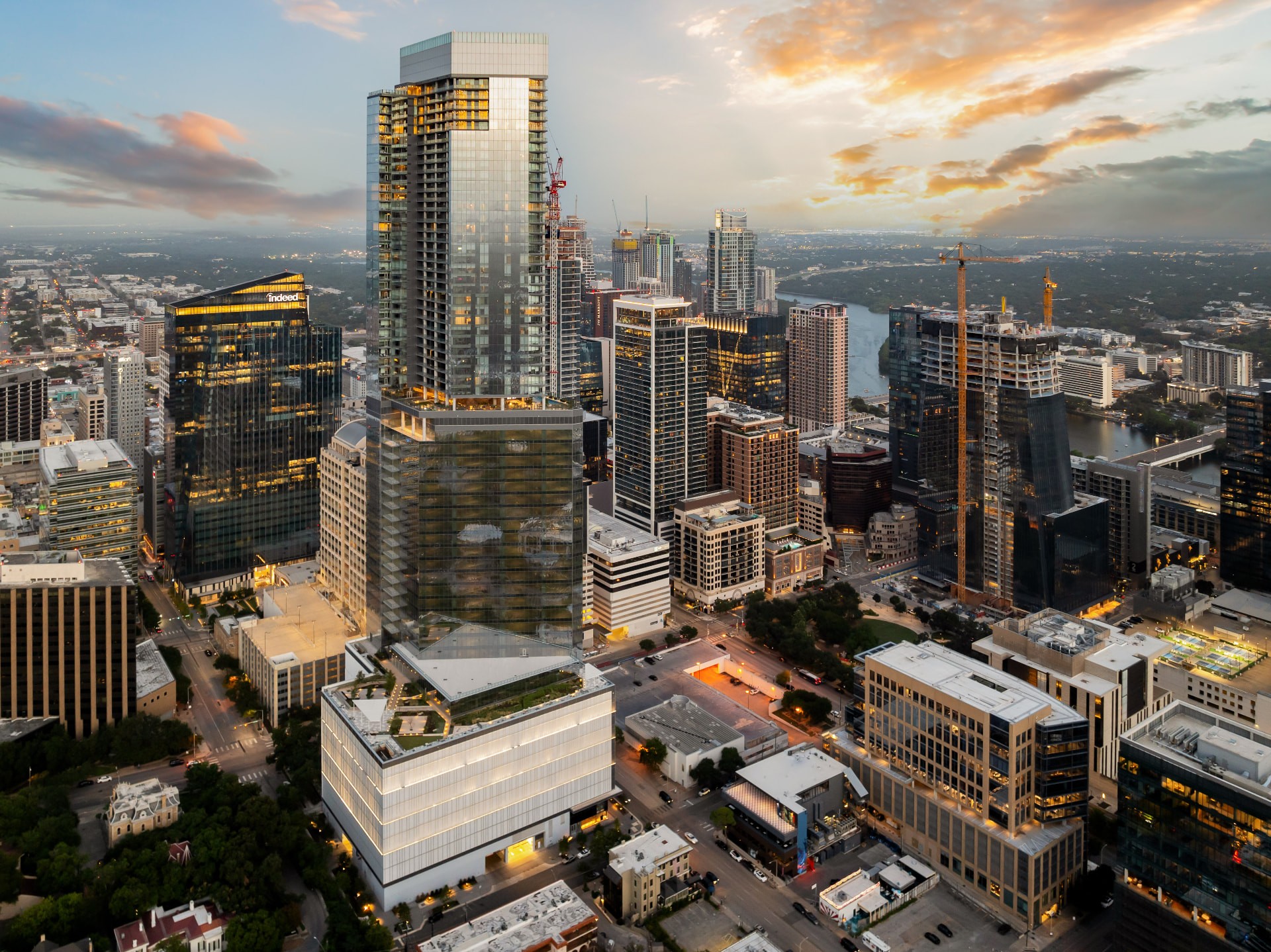Residences at 6G rising over the downtown Austin skyline at sunset