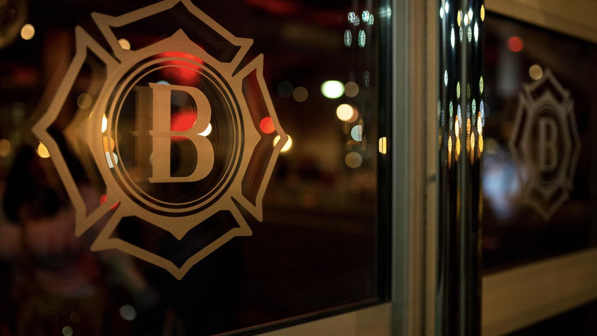 The Battalion monogram in gold on the glass