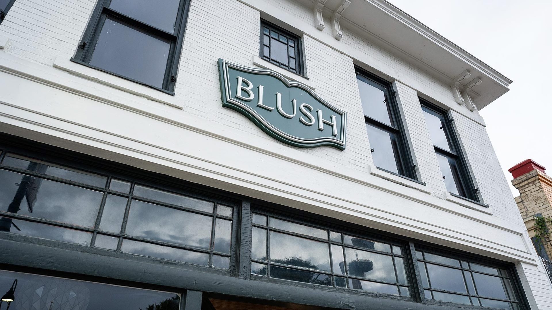 The BLUSH blade sign on the facade, downtown San Antonio