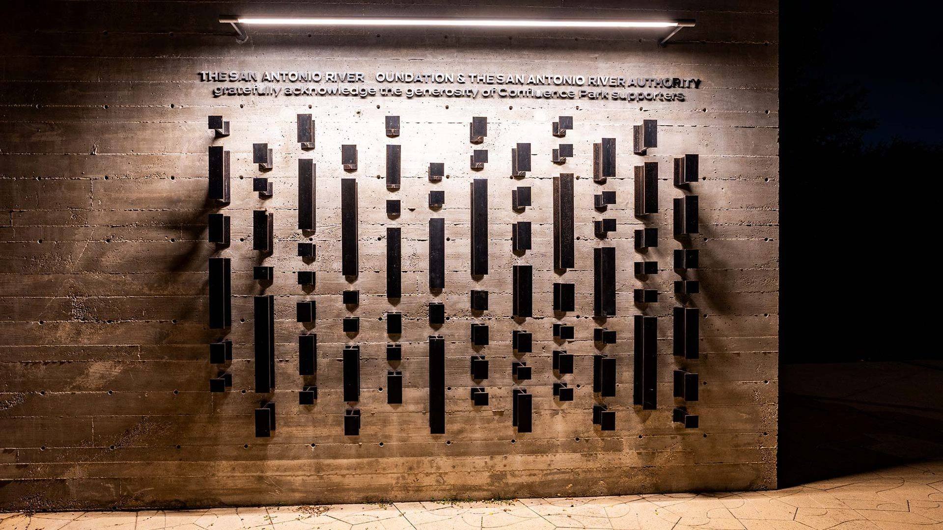 The donor wall lit after dark