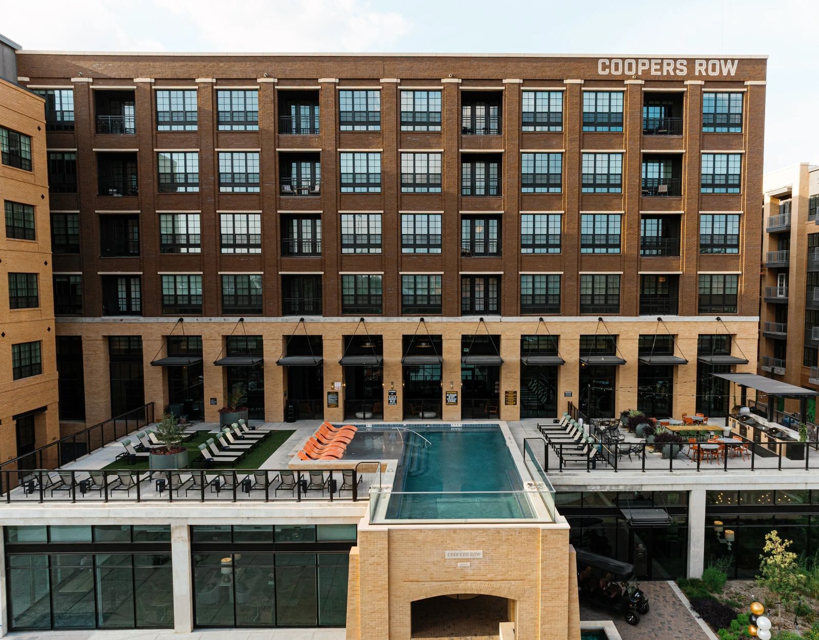 COOPERS ROW lettering on the brick facade above the courtyard pool, San Antonio