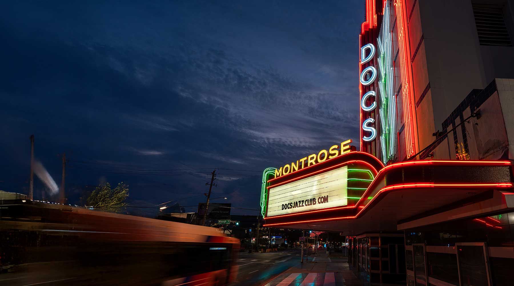 The DOC'S marquee and MONTROSE neon lit at dusk on Westheimer, Houston