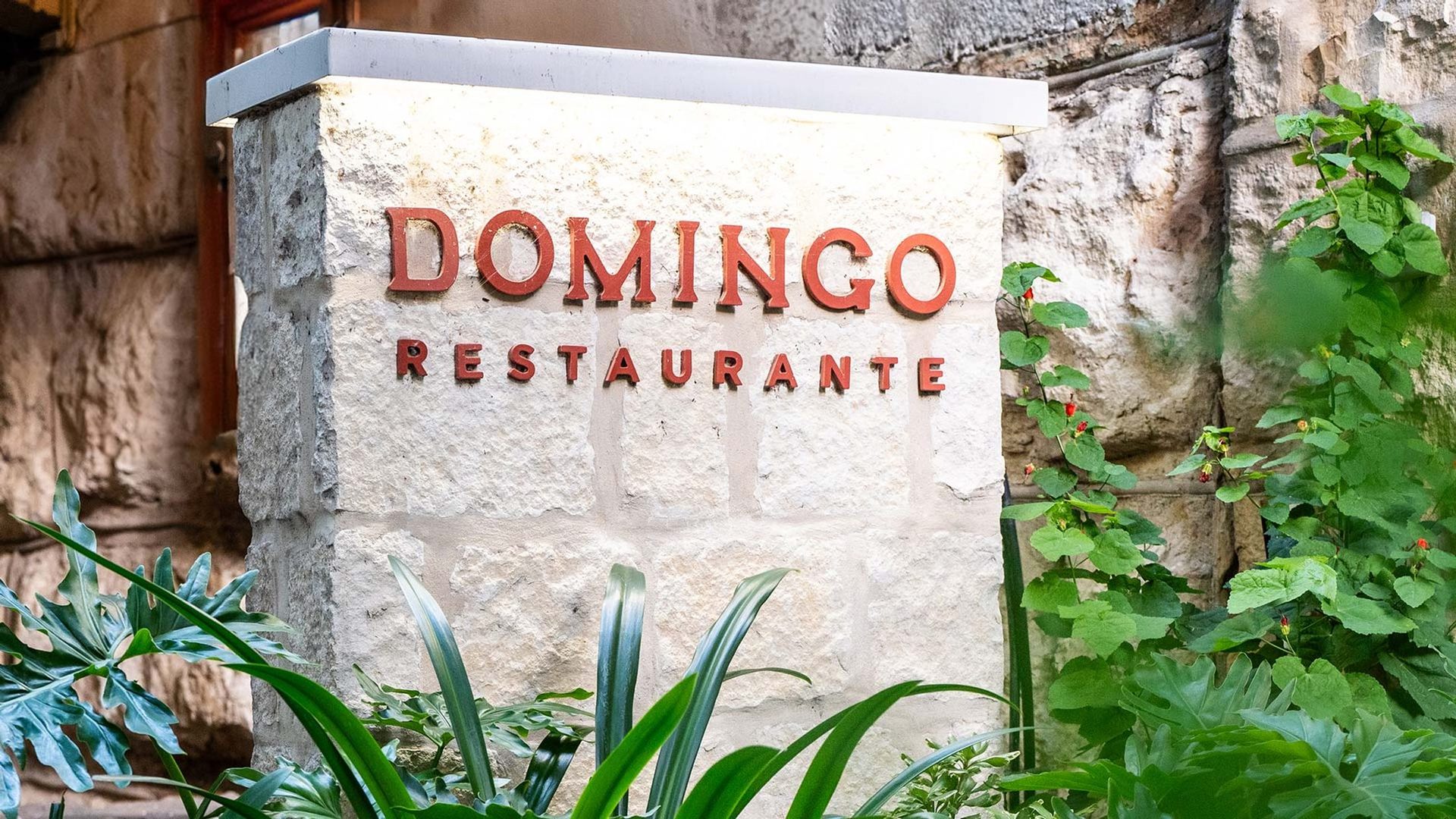 The DOMINGO RESTAURANTE monument sign on the San Antonio River Walk
