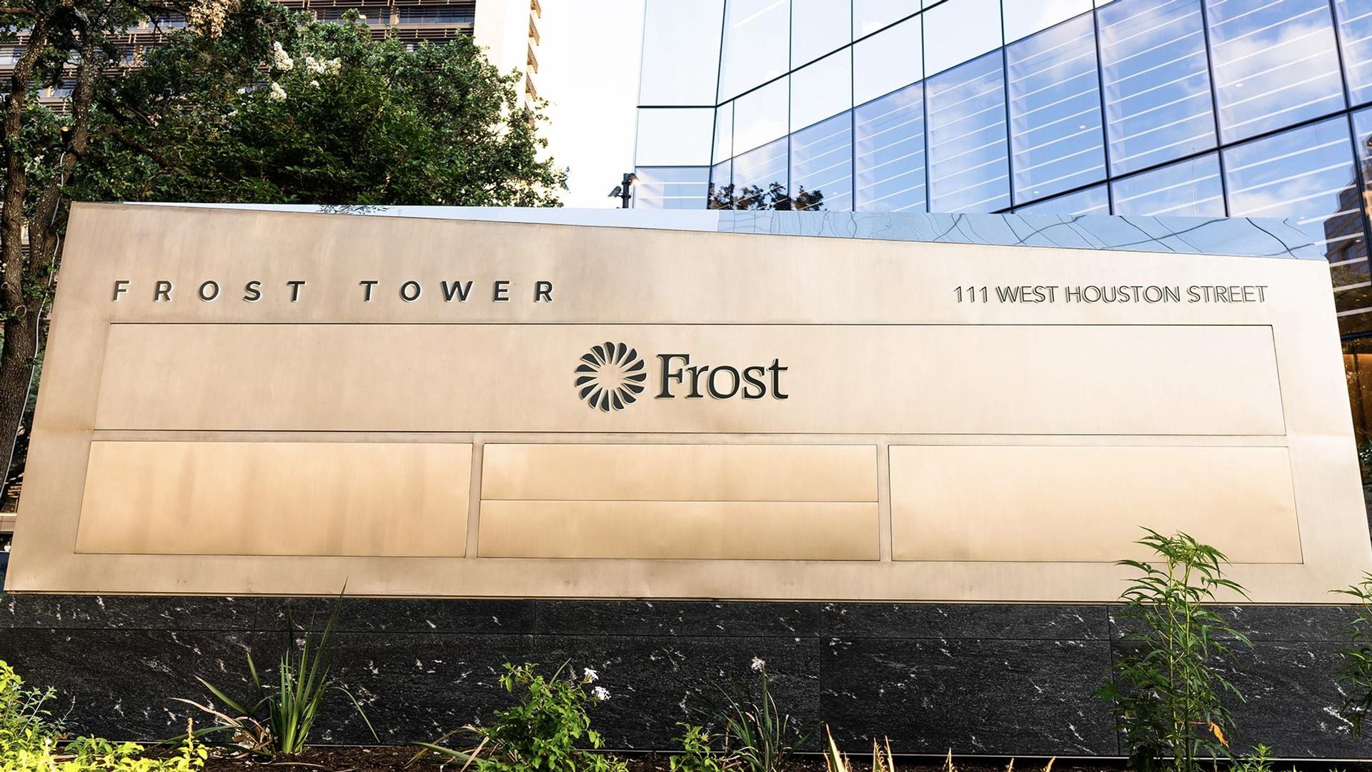 The monument sign at 111 West Houston Street