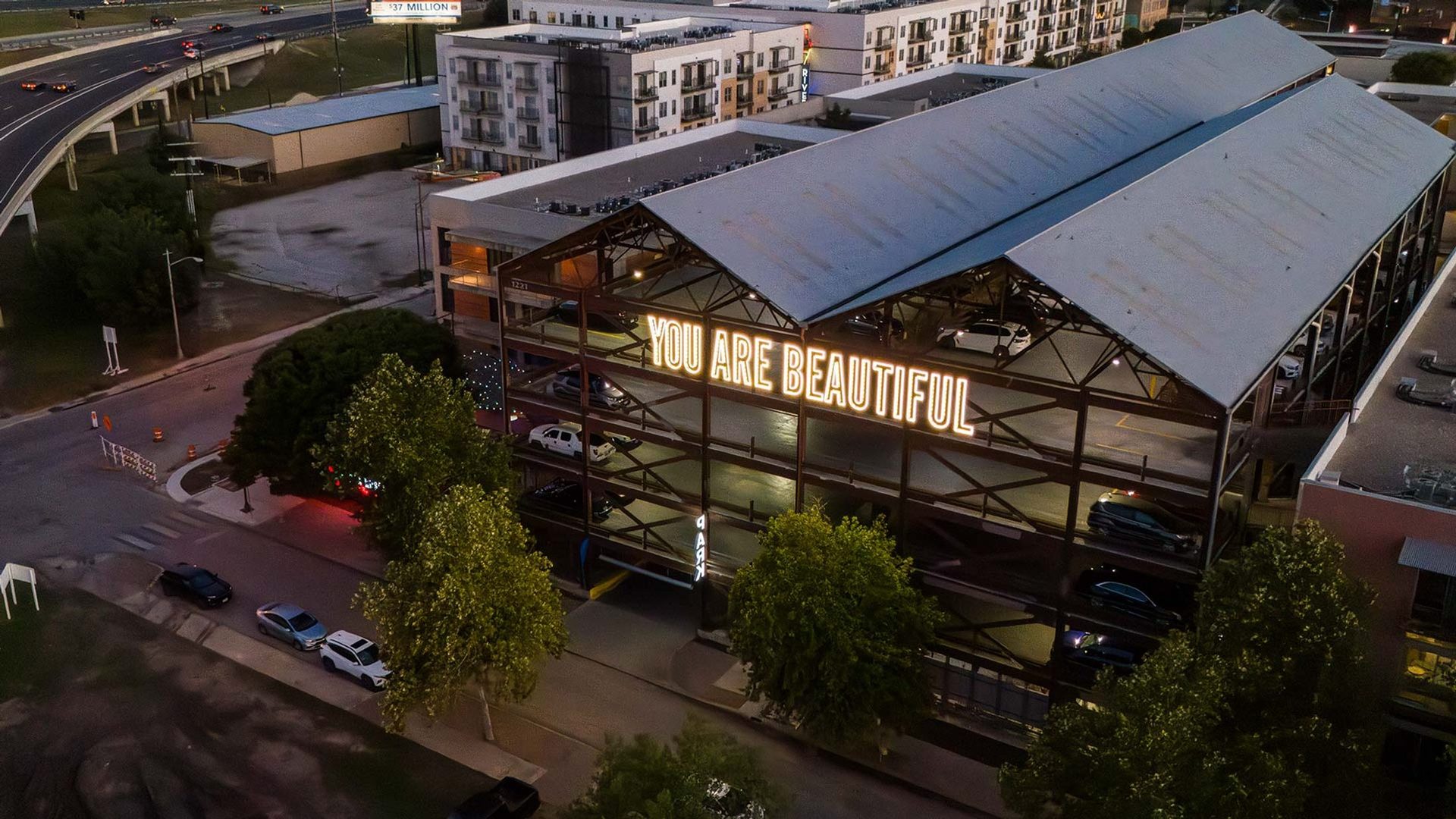 The letterforms above the city at dusk